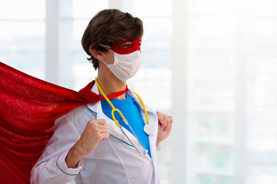 Doctor or nurse in face mask and superhero cape.