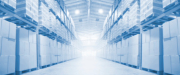 blurred interior of warehouse for logistics background, rows of tall shelves, wide panorama industrial warehouse background, 