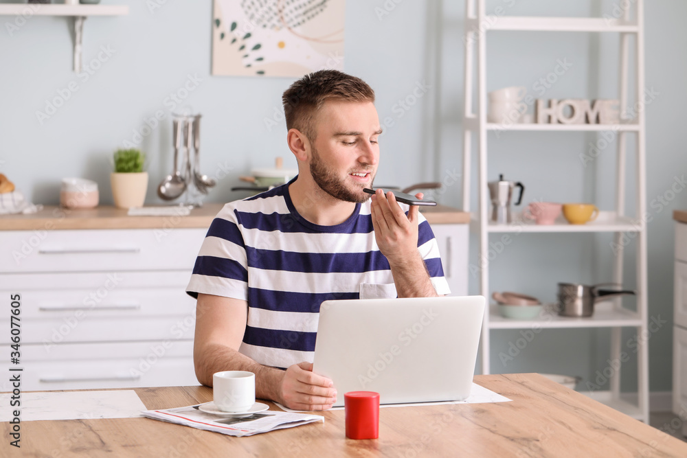 Sticker Young man with smart home assistant device in kitchen