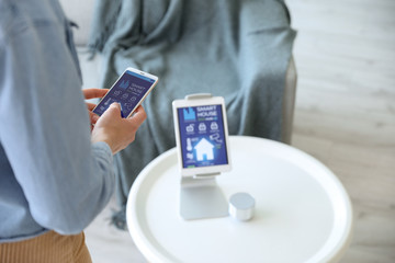 Woman using application of smart home automation