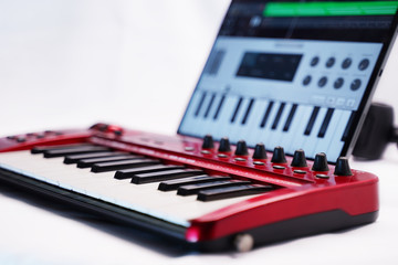 Red Midi keyboard with headphones and software