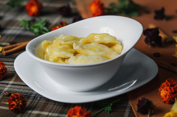 Dumplings on a white platter. Melted butter on the dumplings.