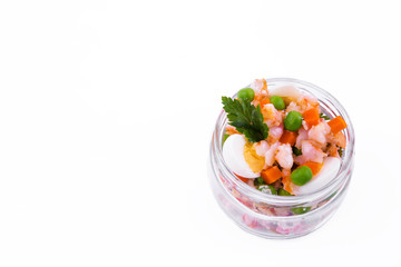Olivier salad with shrimp in a jar on a white background
