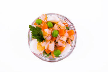 Olivier salad with shrimp in a jar on a white background