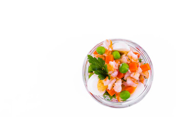 Olivier salad with shrimp in a jar on a white background