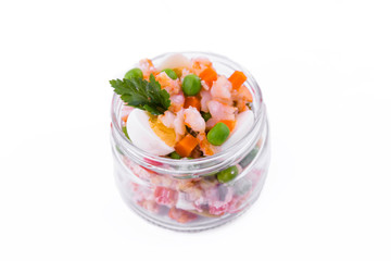 Olivier salad with shrimp in a jar on a white background