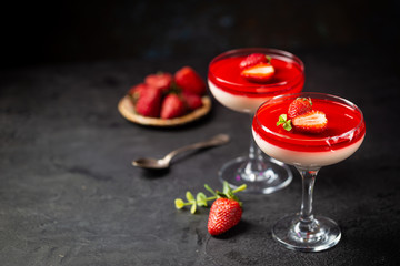 Italian panna cotta dessert with strawberry sirup and mint leaf