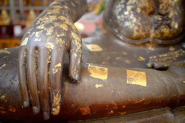 The hand of the Buddha with a gold plate covering