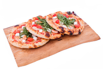 Three pizzas with prawns, tomatoes, arugula and cheese on a wooden tray. The object is isolated on a white background.