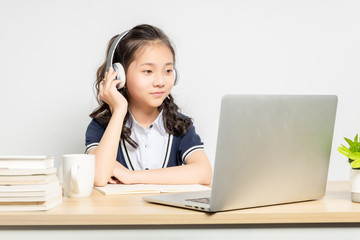Asian primary school girls taking online classes