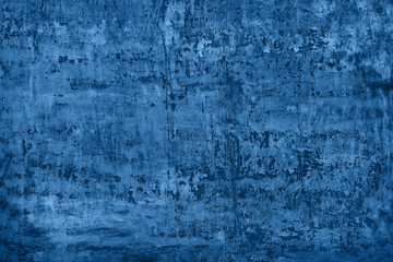 shabby blue stucco with cracks and flakes of paint