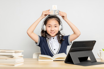 Asian primary school girls who are taking English online courses

