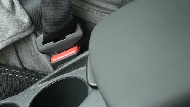 Fastening 3-point seat belt on car bracket on passenger side 4K video