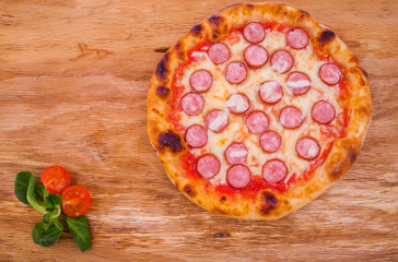 Tasty pepperoni pizza. Top view of hot pepperoni pizza on wood background