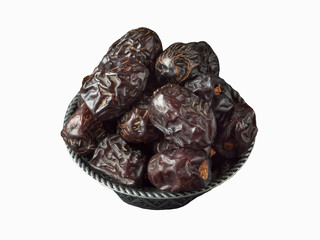 Isolated Saudi Ajwa dates in a bowl. Top view