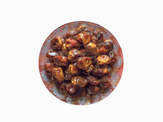 Isolated dates in bowl with syrup. Iftar dates