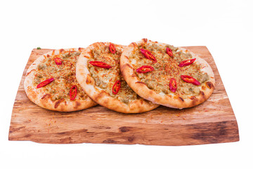 Three Pizza with curry sauce, meat, red pepper on a wooden background. The object is isolated on a white background.