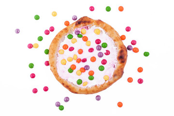 Sweet pizza with marshmallow sauce and colored sweets on a white background