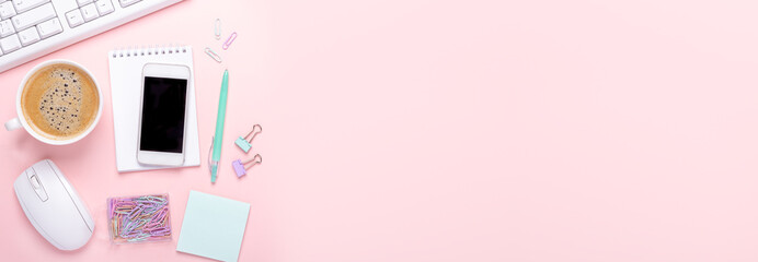 Horizontal banner with cup of coffee, smartphone and stationery accessories on pink background. Top view. Copy space