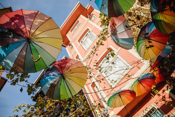Fototapeta na wymiar Colorful hanging umbrellas overhead on street