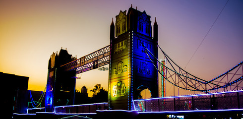 Artificial river bridge covered in lights in diwali fair
