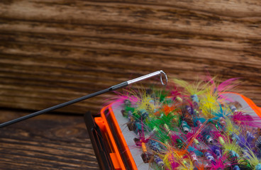 fishing rod whip, close-up, on the background of the bait box, on a wooden background © kurgu128