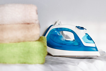 Stay at home concept : Steaming iron on ironing board with copy space,Activities at home Ironing and folding towels