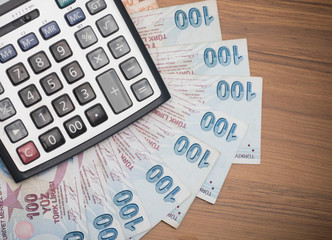 turkish lira banknotes on the table, minimum wage on the calculator screen - obrazy, fototapety, plakaty