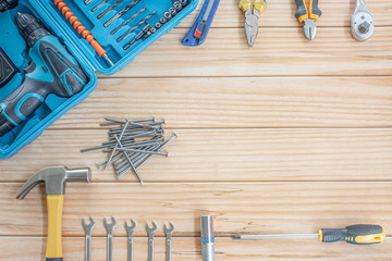 screw,Tools worker, hammer, screwdriver, pliers ,drill,on a wood background, top view