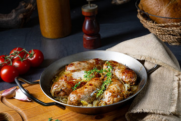 Homemade white sausage fried with onion and herbs