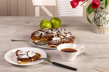 delicious beautiful cake with cream on the table and a Cup of tea