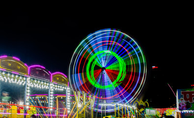 Night View of Amusement park rides, Ferris Wheel in diwali fair
