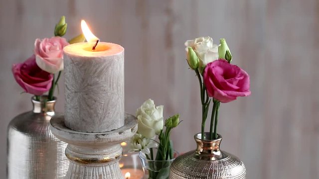 Beautiful party table decoration with golden candles and pink eustoma flowers