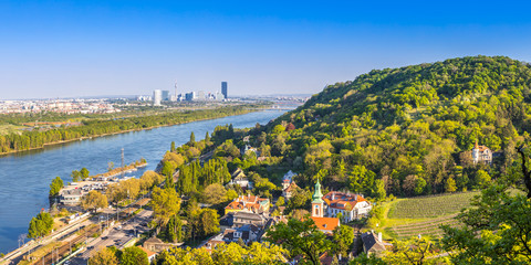 View of Vienna suburbs - Kahlenbergdorf with view of danube river, danube island and Vienna skyline in the back, Austria