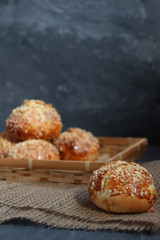 Bread rolls on dark rustic background, on burlap.