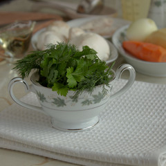 herbs in beautiful bowl on the white napkin against the ingridients