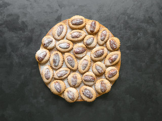 Eid Dates sweets on a black table, top view, copy space