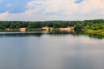 Fototapeta na wymiar View of a beautiful lake in a pine forest at summer