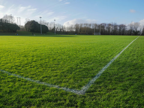 Sport field to play Irish National sports football, rugby, hurling and camogie. Goal post in foreground, Blue cloudy sky.