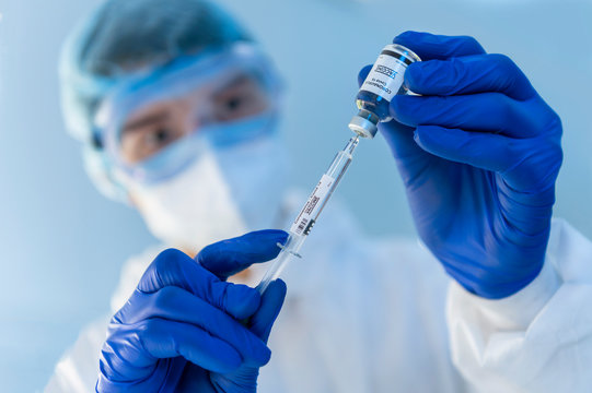 virus experts discover coronavirus covid 19 vacinne holding  syringe labelled coronavirus covid 19 in laboratory