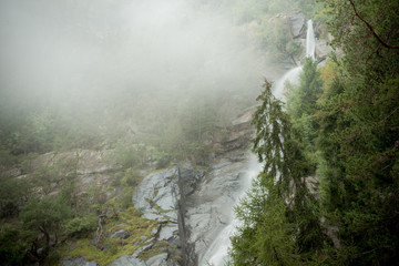 waterfall among the misty forest in Italy