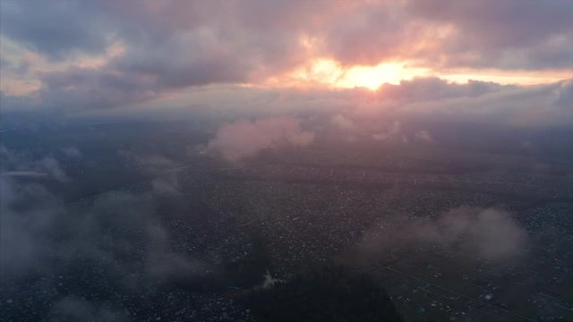 Aerial view of the rural area and clouds running in the sky at sunset