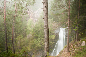 waterfall among the misty forest in Italy