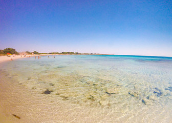 Wonderful sandy beach with transparent crystal clear water in summer in Salento, Puglia, Italy 