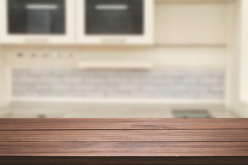 Obraz premium Wood desk space and blurred of kitchen background. for product display montage. business presentation.