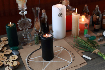 magic ritual with runes and pentagram and magical attributes