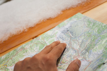 a trekker checking a map during his trip