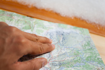 a trekker checking a map during his trip