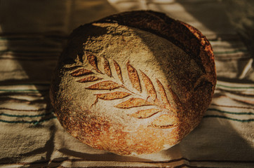 Section of a handmade sourdough bread with beautiful crafted decor
