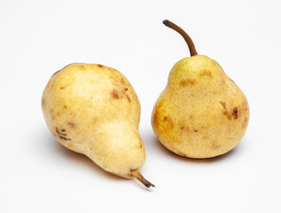two yellow ripe pears on a white background